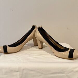 Stuart Weitzman, size 6.  Bone patent leather in color with black accents.